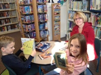 The Stock family enjoys books at the Westport Branch. Stock family for FRAM