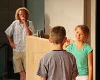John Mulvey (background) teaches kids to act with confidence.