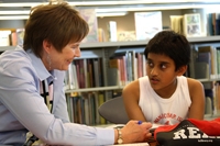Volunteer Renee VanErp shares the Joy of Reading with 10-year-old Parijat Mondal in the Plaza Kids' Corner. Volunteer Renee VanErp shares the Joy of Reading with 10-year-old Parijat Mondal in the Plaza Kids' Corner.