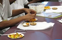 On the menu: peaches, cream cheese and fresh basil on bagels.