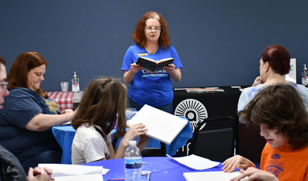 woman reads aloud to group