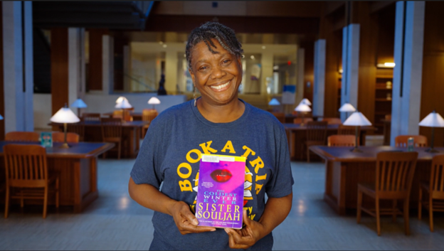 woman smiling holding book