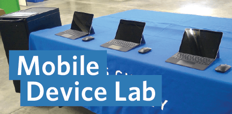 table with three open laptops