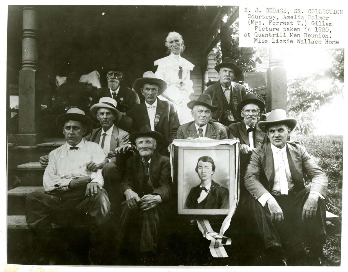 Attendees of the 1920 reunion at Wallace Grove with a picture of a young Quantrill. A special guest was Jesse James Jr. (front right), son of the famous outlaw. Lizzie “Aunt E” Wallace is back-row center.