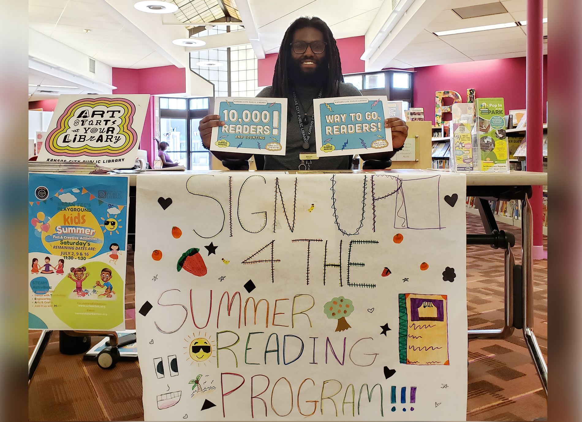 library staff member with signs