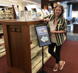 Staff member holding street sheet in Library