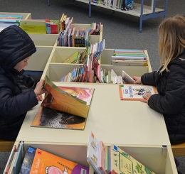 two kids sitting reading books