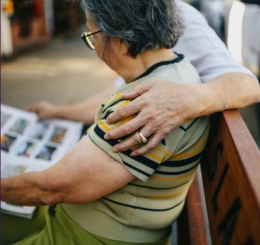 woman looking at album with an arm around her