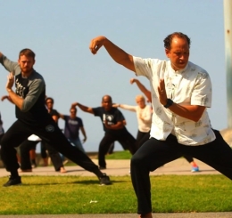 adults doing tai chi outdoors