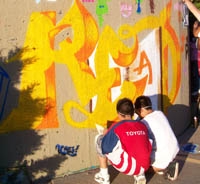 Kids from the Hip-Hop Academy work on the North-East Branch's mural.