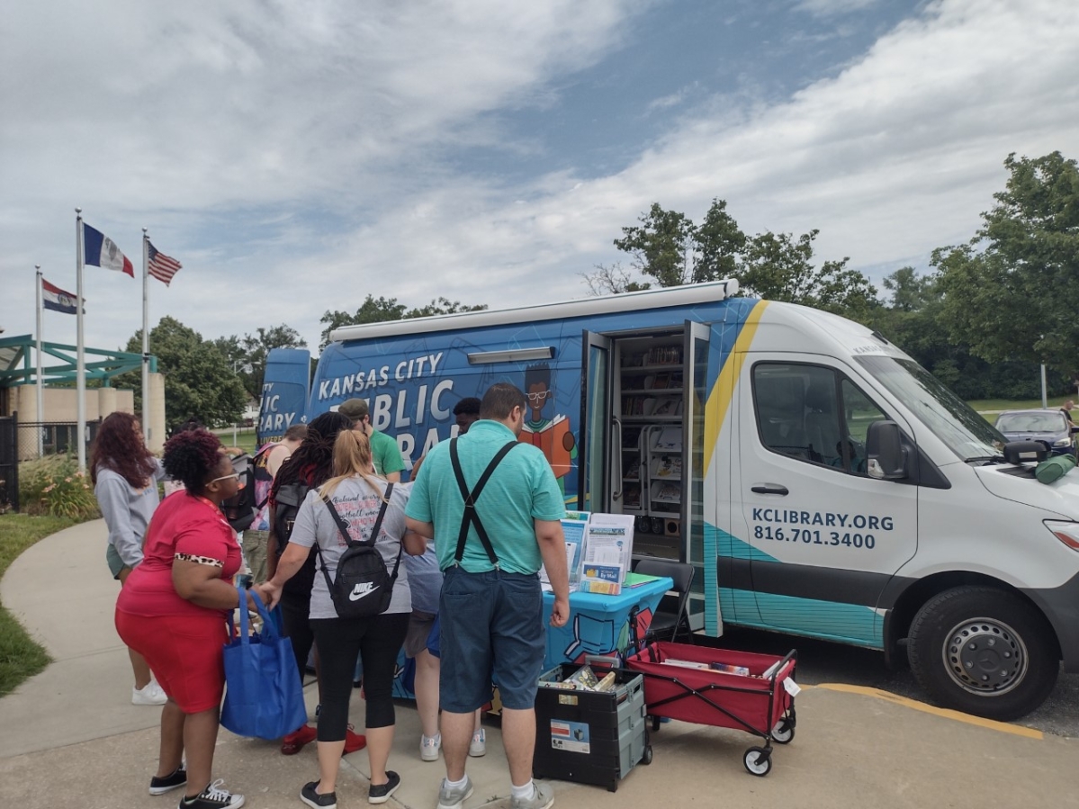 A group of people outside the bookmobile