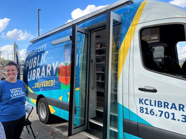 library employee stands outside of Bookmobile